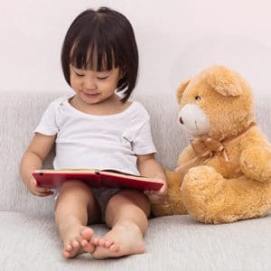 Uplevel-Medical-Practice-Through-Storytelling-Child-Reading-to-Teddy-Bear