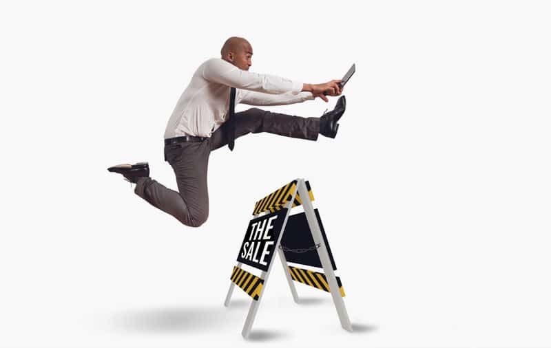 Businessman-Leaping-Over-Hurdle-with-Sales-Presentation